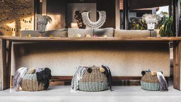 A room with a sofa, decorative items, and woven baskets.