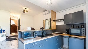 A modern kitchen with a built-in microwave, a coffee maker, and a sink. - La Plage d'Irène (Appartement n°36) - Avec balcon (San-Nicolao)