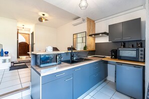 A modern kitchen with a built-in microwave, a coffee maker, and a sink. - La Plage d'Irène (Appartement n°36) - Avec balcon (San-Nicolao)