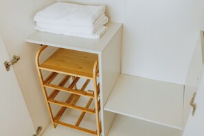 A white cabinet with a wooden shelf and a folded white towel on top. - 701 Cozy 1-bedroom Condo in Nimman - 4 mins walk to Maya Mall and One Nimman (Chang Wat Chiang Mai)