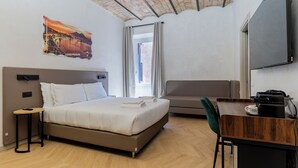 A hotel room with a bed, a desk, a chair, a flat-screen TV, and a window with curtains. - Urban Vatican Rooms Cities of Art (Roma)