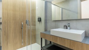 A modern bathroom with a glass shower enclosure, a wooden vanity, and a large mirror. - Urban Vatican Rooms Cities of Art (Roma)