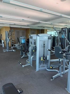 A gym with various exercise machines, including a leg press and a chest press. - Dream Stay (Fort Myers)