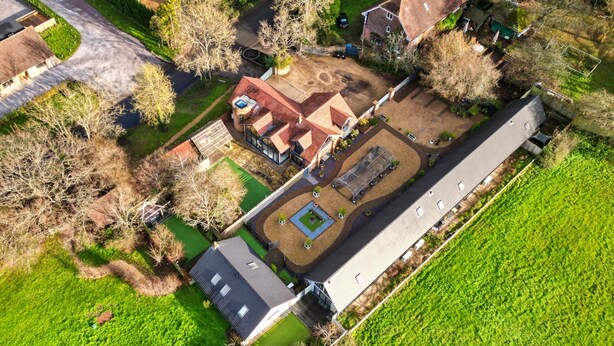 An aerial view of a residential property with a large house, a garden, and a long driveway. - Peaceful Dorset Cottage for 4 (Wimborne)