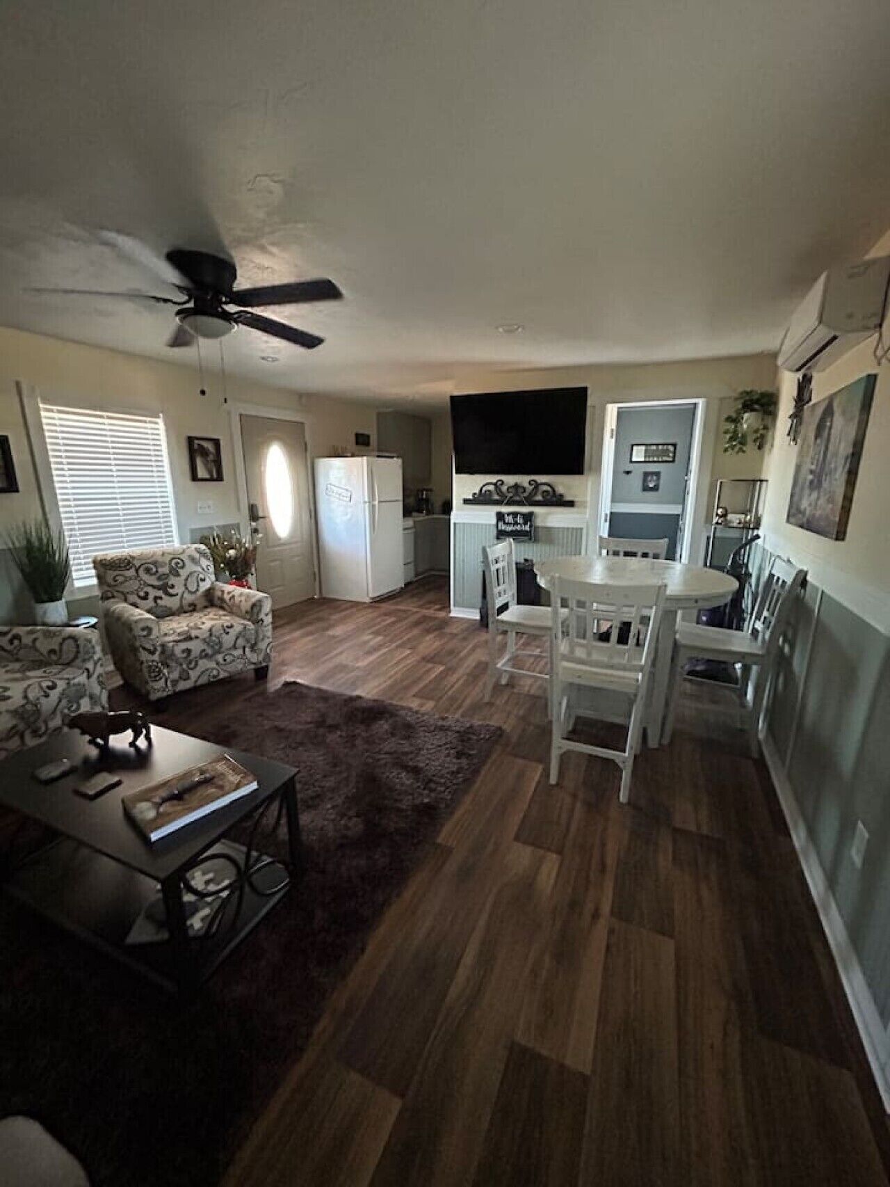 A compact living space with a dining area, kitchen, and seating.