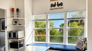 A kitchen with a built-in bench, a microwave, and a toaster oven. - Copano Bay Waterfront Cottage with 300 Ft Fishing Pier, sleeps 8, Pets Ok (Bayside)