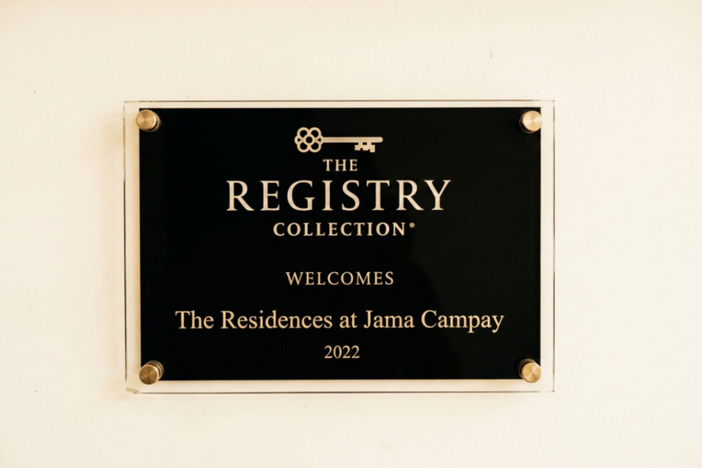 A plaque with the text 'THE REGISTRY COLLECTION' and 'WELCOMES The Residences at Jama Campay 2022'.