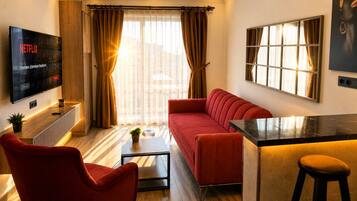 Quarto superluxo, vista para a cidade | Área de estar