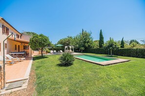 A residential property with a swimming pool, outdoor seating, and a well-maintained lawn. - Private Pool Villa in Pollensa (Pollensa / Pollença)