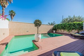 A rooftop pool area with a clear blue sky, a small tree, and a wooden deck. - Beach Chalet with Pool for 6 (Alcudia)