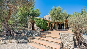 A stone building with a stone staircase leading to a door, surrounded by olive trees and a clear sky. - Villa near Pollensa Old Town (Pollensa / Pollença)