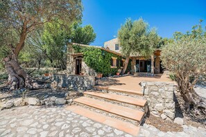 A stone building with a stone staircase leading to a door, surrounded by olive trees and a clear sky. - Villa near Pollensa Old Town (Pollensa / Pollença)