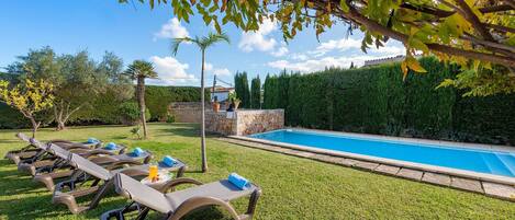 A poolside area with lounge chairs and a swimming pool.