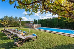 A poolside area with lounge chairs and a swimming pool. - Villa near Pollença Town Centre (Pollensa / Pollença)