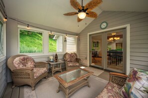 A covered porch with wicker furniture, a ceiling fan, and a view of the outdoors. - New! Mountain Lake Area Getaway w/ Hot Tub! (Oakland)