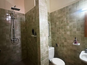 Un baño con ducha, inodoro y lavamanos.