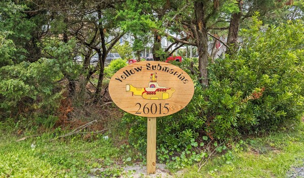 A wooden sign with a yellow submarine illustration and the text 'Yellow Submarine 26015'.