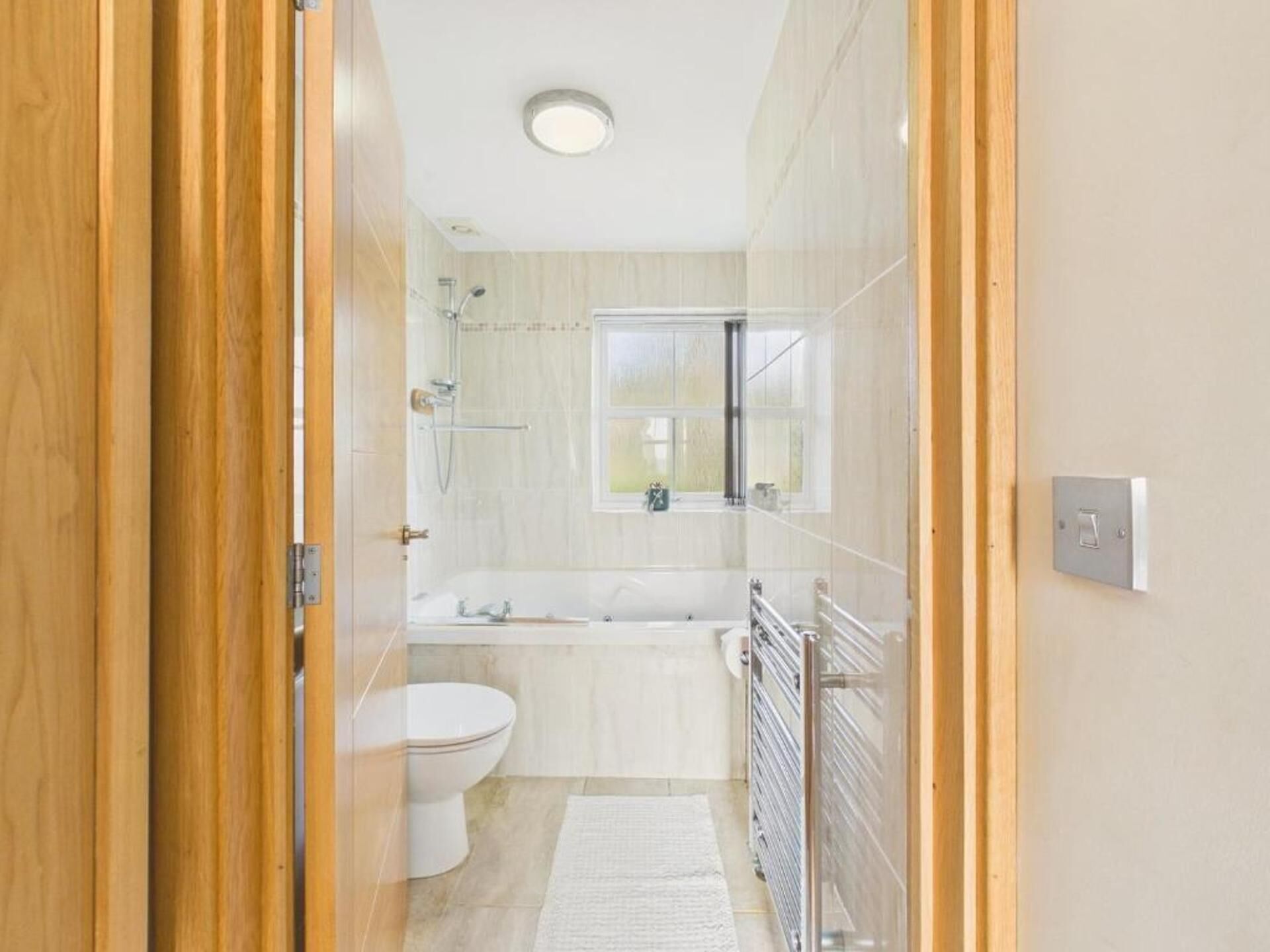 A modern bathroom with a toilet, sink, and bathtub.
