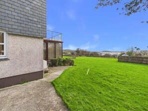 A house with a well-maintained lawn and a clear sky. - Apartment Sleeps 4 Enclosed Garden Pets Welcome (Falmouth)
