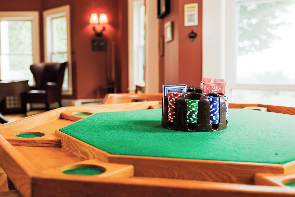 A pool table with poker chips and a 'Classic Games' sign.