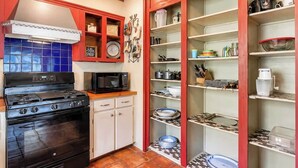 A kitchen with a stove, microwave, and cabinets. - Secluded Mountain Paradise, Hot Tub, Firepit, View (Sevierville)