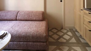 A room with a sofa, a door, and cabinets. - Architect-designed apartment near Beaugrenelle (Paris)