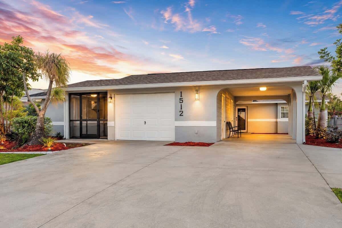 A modern two-story house with a garage, a covered entryway, and a well-maintained front yard.