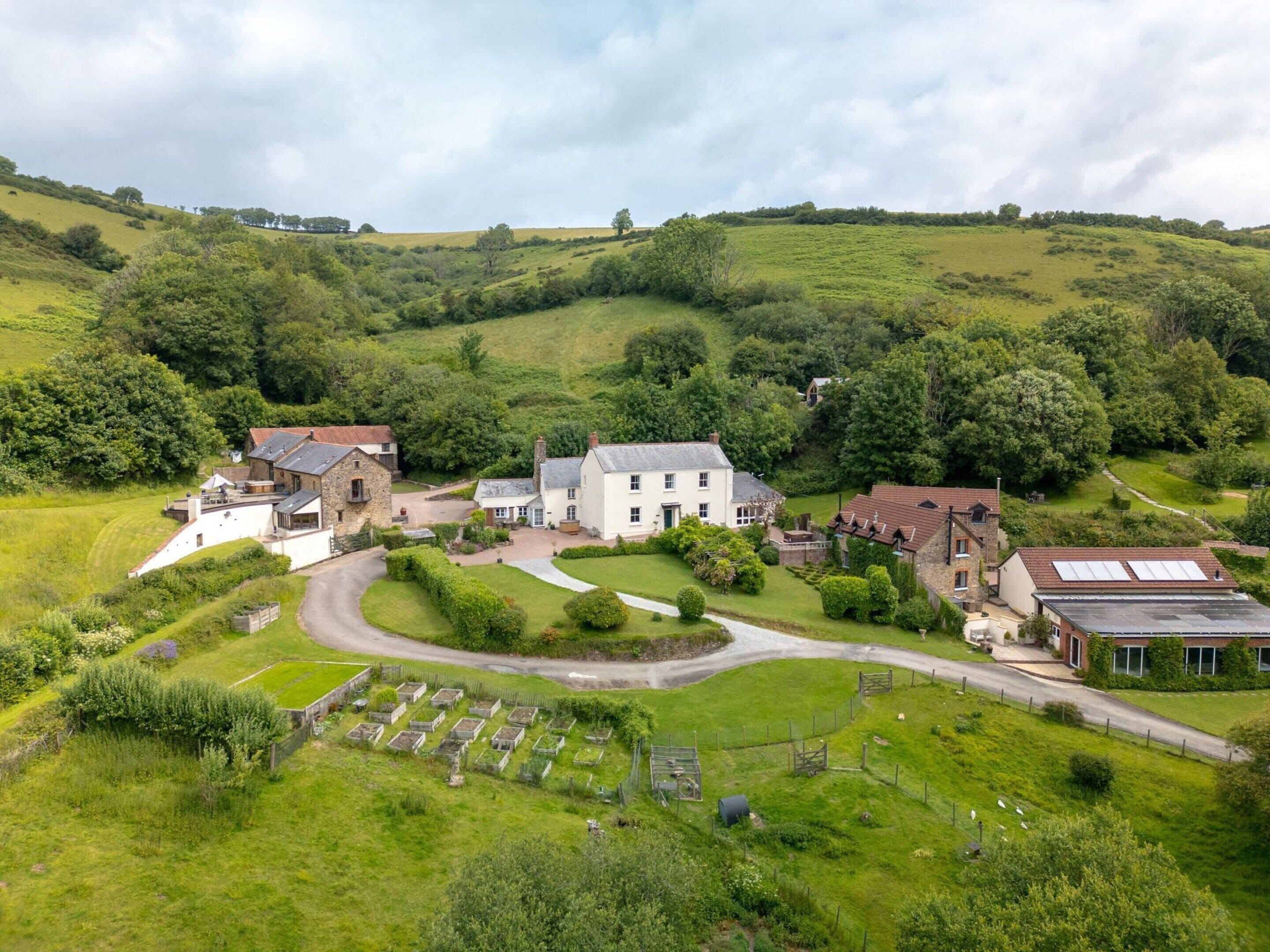 A rural estate with multiple buildings, a winding driveway, and a cemetery.