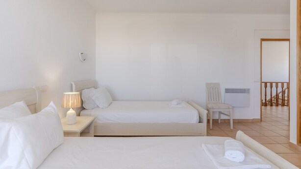 A hotel room with two beds, a chair, a lamp, and a window. - #416 Spacious Villa | Private Pool, BBQ, and Parking (Albufeira)