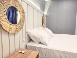 A hotel room with a bed, a bedside table, and two wall-mounted mirrors. - Bravavel na Praia Brava by LikeHome (Balneário Camboriú)