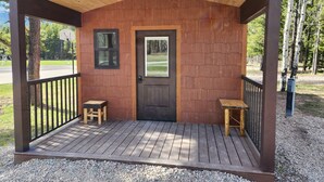 Una cabaña de madera con un porche, una puerta y un letrero que dice 'Snowslip'.
