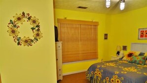 A bedroom with a bed, a dresser, a window with blinds, and a wall decoration. - Nature Lover’s Retreat: Cozy 2-Bedroom Pine Mountain Cabin near Callaway Gardens (Pine Mountain)