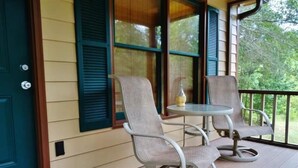 A porch with two chairs and a small table, a green doormat, and a door with a lock. - Nature Lover’s Retreat: Cozy 2-Bedroom Pine Mountain Cabin near Callaway Gardens (Pine Mountain)