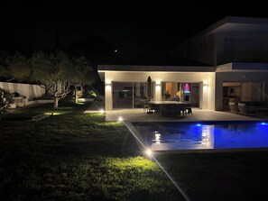 A modern house with a swimming pool, outdoor seating, and a well-lit patio area. - Exceptional new contemporary villa with air conditioning, ocean views, a private pool, and a hot tub (Saint-Cyr-sur-Mer)