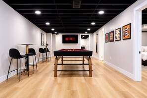 A modern interior with a pool table, bar area, and artwork on the walls. - Theater · HotTub · PoolTable · Walk ND · Sleeps 12 (South Bend)