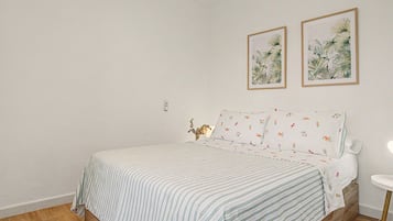 Tabla de planchar con plancha y ropa de cama