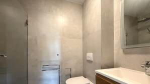 A modern bathroom with a shower, toilet, and vanity. - Two Bedroom Sea View Apartment Marisol (Mrljane)