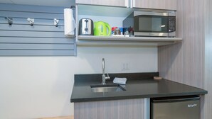 A compact kitchen with a built-in microwave, a sink, and a small countertop. - Adjoining rooms create a wonderful space with modern finishes (Telluride)