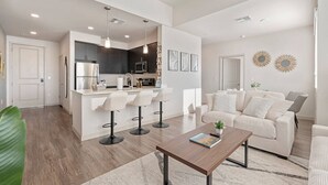 A modern living space with a kitchen, dining area, and seating area. - 3BR Tempe Gem - Pool, King Beds, Gym, ASU Nearby (Tempe)