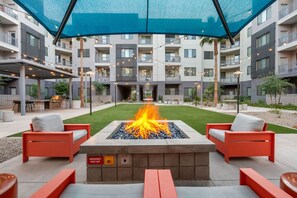 An outdoor patio with a fire feature, seating, and a covered area. - Rest & Recover - King Bed, Pool, Gym & More (Tempe)