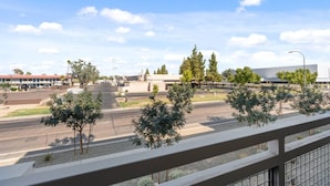 A street view with a building, trees, and a clear sky. - Tempe Oasis | King Beds, Pool, Gym, DT Tempe & ASU (Tempe)