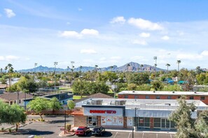 A Dunkin' Donuts store with a parking lot and a mountain range in the background. - 1BR Tempe Haven - King Bed, Pool, Hot Tub, Gym (Tempe)