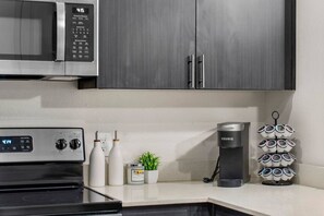 A kitchen with a microwave, coffee maker, and a coffee pod holder. - Luxury 2BR: King Beds, Pool - Near DT Tempe & ASU (Tempe)