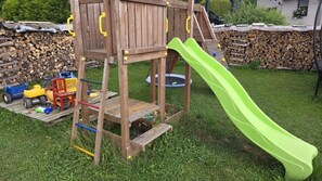 A wooden play structure with a slide in a grassy backyard. - NEW! Vacation Rental on Schanzenbach (Hartha)