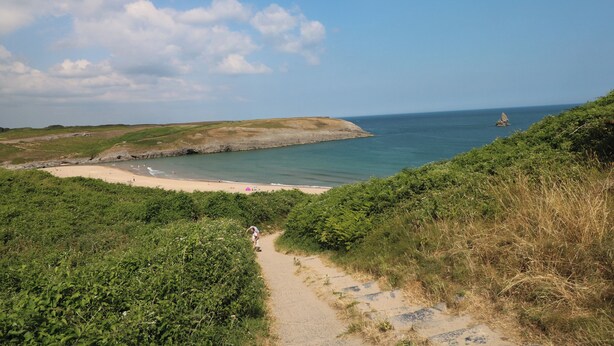 A coastal landscape with a sandy beach, a clear sky, and a path leading to the sea. - St.twynells Farm (Pembroke)