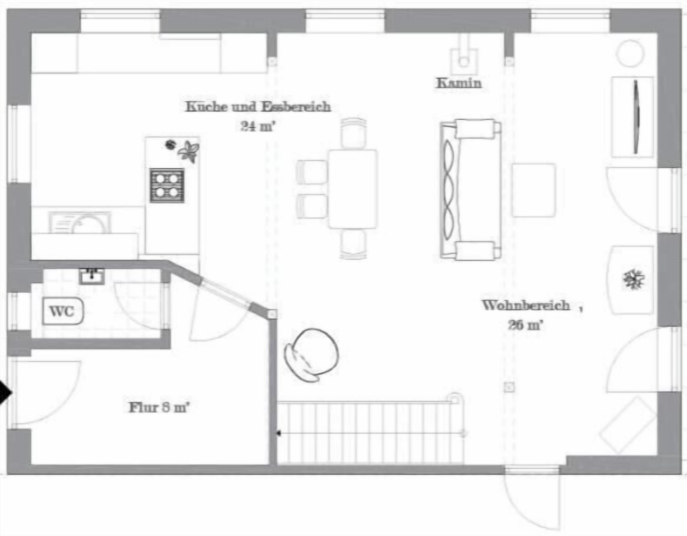 Een plattegrond van een hotelkamer met keuken, toilet en zithoek.