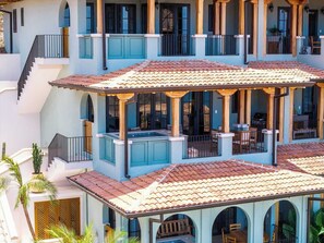 A multi-story building with balconies, outdoor seating, and a pool area. - Las Catalinas Escape, Ocean View & Plunge Pool (Las Catalinas)