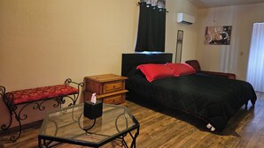 A bedroom with a bed, bedside table, nightstand, and a window with curtains. - Red Rock Rendezvous - Steps Away From Uptown Sedona Shops & Dining (Sedona)