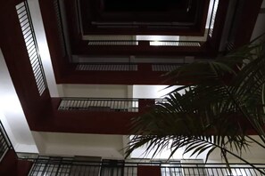 A multi-level building with balconies and a palm tree in the foreground. - Serene Palace (Nairobi)