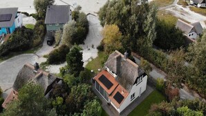 A coastal residential area with houses, a beach, and a road. - Beach Villa With Sauna in Makkum (Makkum)